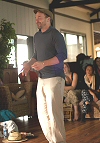Photo of Brendan Taaffe leading songs with a group by a bonfire