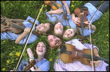 Photo of Brendan Taaffe with a group of young musicians.